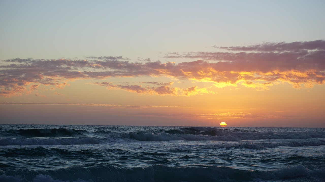 Mesmerizing sunset over the ocean waves at Destin Beach, Florida.
